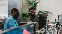 Two colleagues laughing together whilst playing a computer game. Two colleagues laughing together whilst playing a computer game.